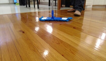 Polished wooden floor being mopped