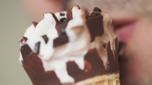 Close-up of a man holding a chocolate cornetto ice cream