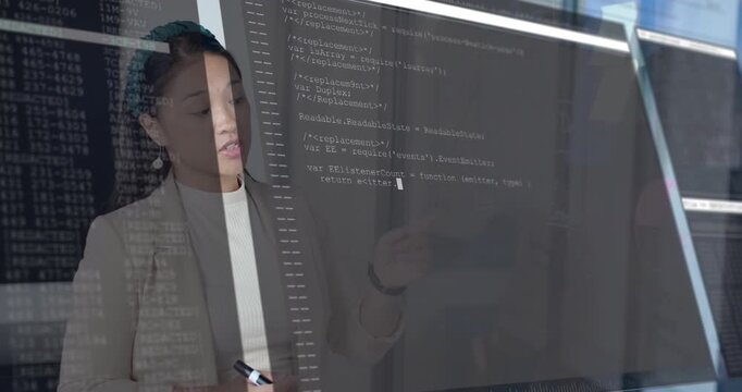 Tech engineer pointing at diagram on glass causing code overlay evolving illustrating concept