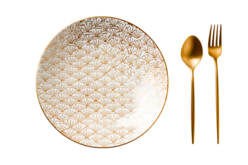 Elegant white plate with golden geometric design accompanied by a golden spoon and fork on a black background