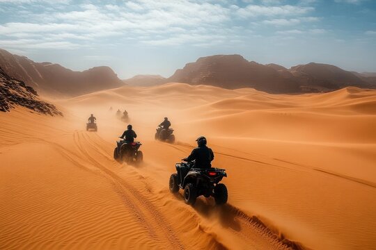 Group of people riding all-terrain vehicles across vast orange desert dunes with rocky mountains in the distance under a clear blue sky - Powered by Adobe
