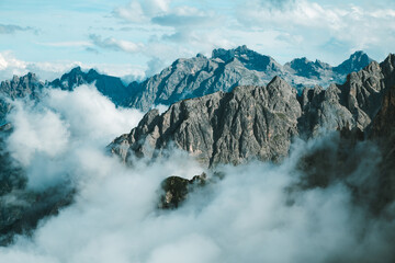 Dramatic View of Tre Cime di Lavaredo Peaks Shrouded in Clouds under Blue Sky