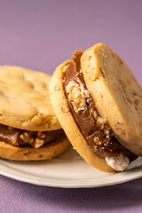 Close-Up of Delicious Cookies with Caramel Filling on a Purple Background