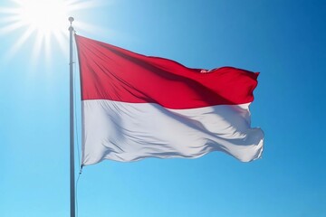 Naklejka premium The Indonesian flag flies under a clear sky