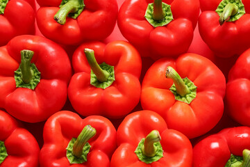 Texture of red bell peppers on color background