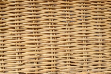 The textured surface of a wicker basket, displaying a rustic, detailed design.