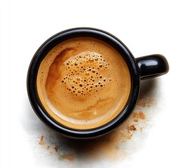 Top view of a black coffee cup filled with freshly brewed espresso showing crema and bubbles on a white surface with coffee powder sprinkled around