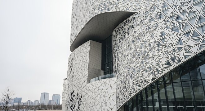 Modern Building Facade with Geometric Triangular Pattern and Curved Design Element