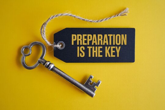 Preparation is the key concept with vintage key and tag on yellow background, planning, success, motivation.
