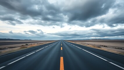 Panoramic view of an empty road under cloudy skies, capturing a serene and open landscape.