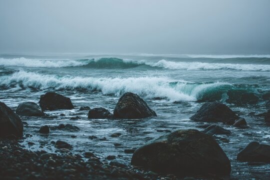 Misty ocean waves crash on a rocky shore