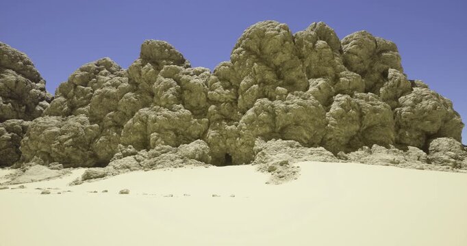 Vast sandy terrain features striking rock formations that resemble clouds. The sun casts sharp shadows, adding depth to the rugged textures of the scene.