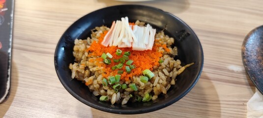 Crab fat fried rice topped with shrimp eggs, shredded crab sticks and chopped Japanese green onions.