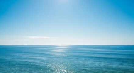 Fototapeta premium Serene seascape featuring clear blue sky and calm ocean on a sunny day landscape scene