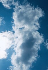 Obraz premium A collection of bright blue sky photographs with various formations of soft white clouds, captured during the day in calming natural light