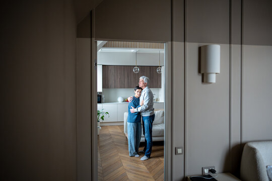 Tired sad mature husband and wife in grief embracing hugging, man comforts wife, holding close. Family crisis, reconciliation after argument, bad news, incurable illness, depression, emotional support