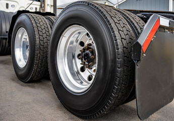 Big rig semi truck tractor dual wheels with large tread on the tires and aluminum rims © vit