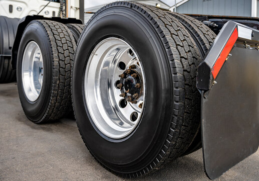 Big rig semi truck tractor dual wheels with large tread on the tires and aluminum rims