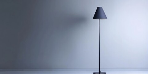 A modern floor lamp with a conical shade stands against a plain, light-colored wall. The lamp has a sleek, minimalist design with a dark metallic finish. 