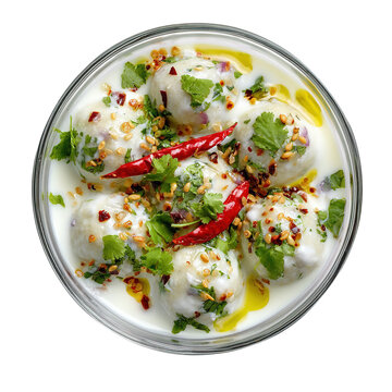 Spicy Indian dhai bhalay or dahi vada, with sweet and spicy sauce, toped with spices and coriander, Isolated on white background.