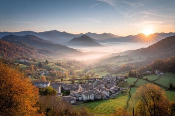 Autumnal village nestled in a valley at sunrise