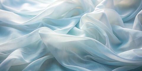 Obraz premium Soft flowing blue and white fabric folds creating a dreamy texture
