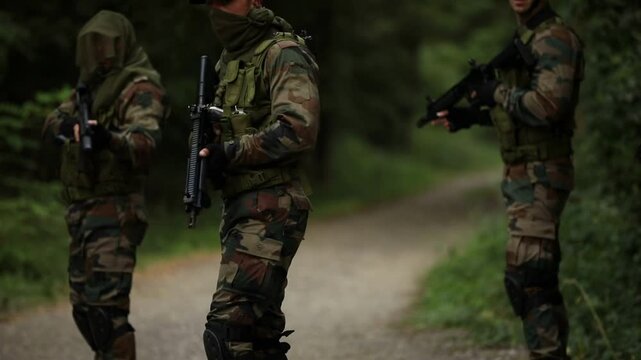 Soldiers moving through forest during tactical action concept of war, Soldiers in full gear patrolling in border nation area