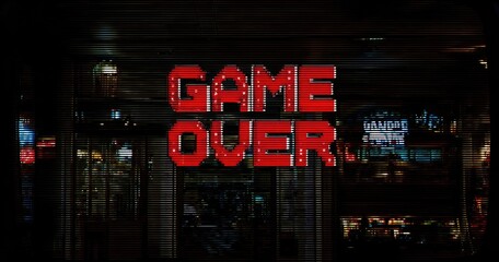 Retro "Game Over" sign on storefront at night