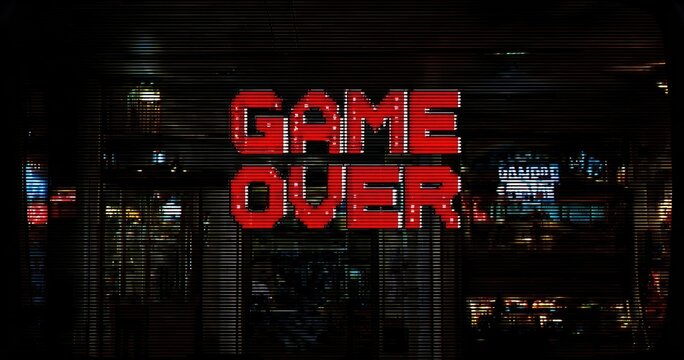 Retro "Game Over" sign on storefront at night