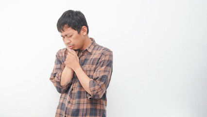 asian young man touching her cheek with facial expression isolated on gray background, suffering...