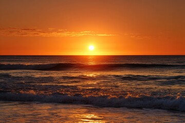 Fototapeta premium Vibrant sunrise over the ocean. Sunrise, golden, waves, horizon, ocean, sea, beach, morning, sky, warm, orange, red, sun, bright, clouds, calm, water, 