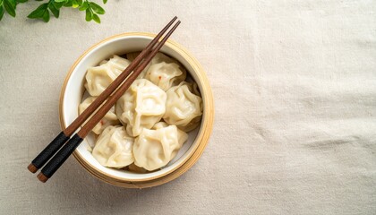 Steaming Hot Dumplings in a Bamboo Steamer with Chopsticks Ready to Eat, Delicious Freshly Made Chinese Dumplings Presented in a Traditional Bamboo Steamer