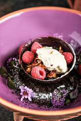Enjoy a lavish dessert adorned with fresh raspberries and floral