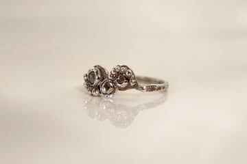 Elegant handmade silver ring with raw gemstones on a white background for stylish women.