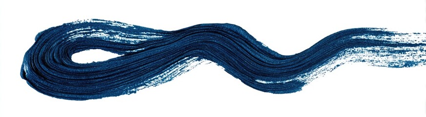 A dynamic, flowing stroke of deep blue paint
