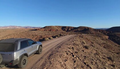 Dusty road with SUV.  Desert landscape