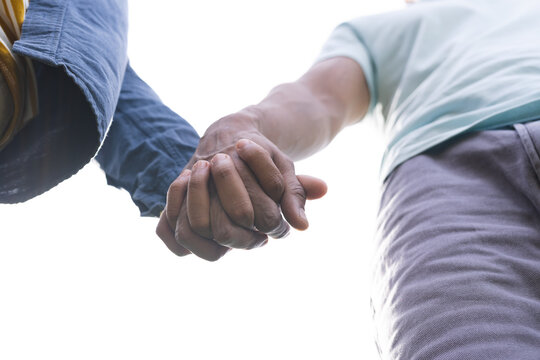 Gay couple holding hands, unaltered