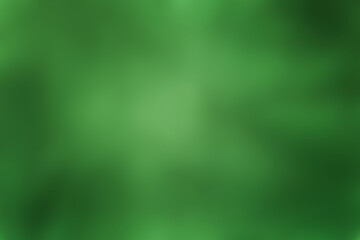 abstract blurred background dark green with light spot in the middle