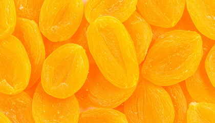 Close-up shot of a pile of dried apricots, showing their vibrant orange color and texture.