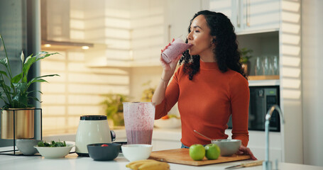 Woman, blender and drinking with smoothie in kitchen for diet, nutrition or wellness in home. Female person, nutritionist or beverage with natural organic fruit for protein shake or vitamins in house