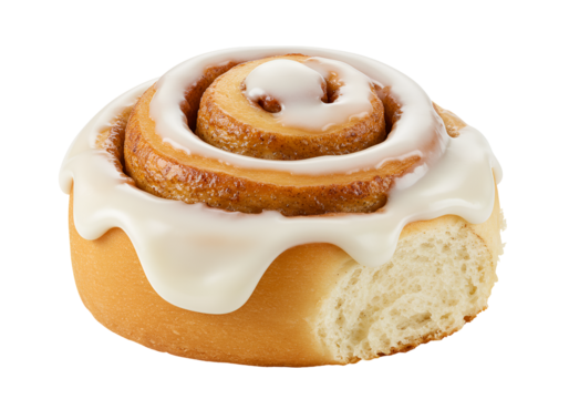 Close-up of a freshly baked cinnamon roll with white icing on a black background