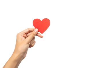 Close-up of a hand holding a red paper heart symbolizing love and compassion against a black