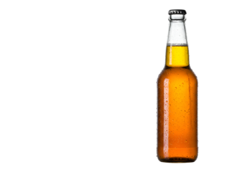 Close-up of an amber-colored glass beer bottle illuminated against a black background