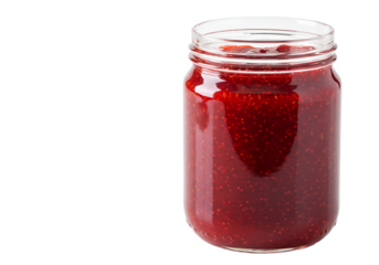 Close-up of fresh strawberry jam inside a clear glass jar with a black background