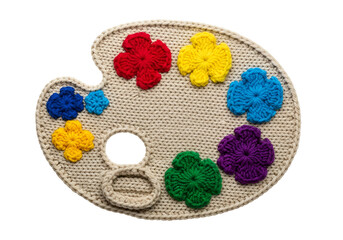 Colorful crocheted artist palette with flower motifs and a hole for mixing paints suitable for