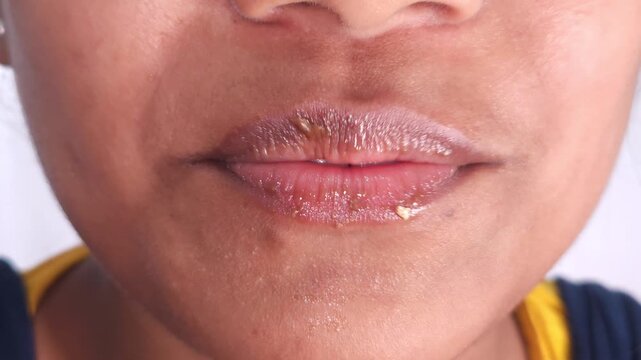 Macro of a Indian girl taking a bite of a chocolate bar with visible creamy and crunchy filling. Intimate and cinematic shot capturing indulgence, 4K resolution FOOTAGE
