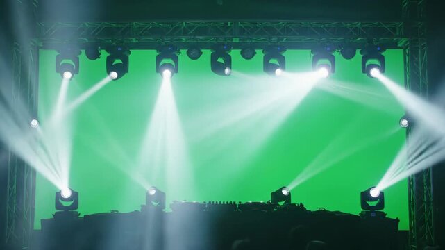 DJ Stage with Green Screen and Spotlights - Multiple spotlights illuminate a DJ stage setup against a vibrant green screen background.