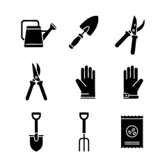 Black silhouette icon set of plants, flowers, watering cans, and cultivation tools for home gardening and agricultural care themes.