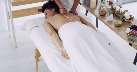 Hands, masseuse and salt on person at spa for exfoliation, detox skin and luxury treatment. Above,...