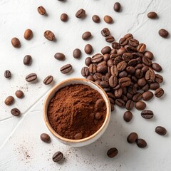 Overhead view of roasted coffee beans and ground coffee in a bowl, isolated on white background